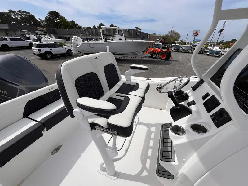 Slide: The Image of 2025 Tidewater 232 LXF boat interior with dual seats and steering console. - 7