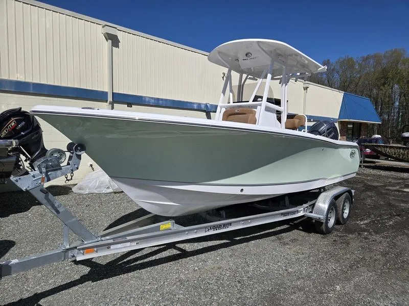Slide: The Image of 2025 Sea Hunt Ultra 229 boat on trailer, parked outdoors. - 1