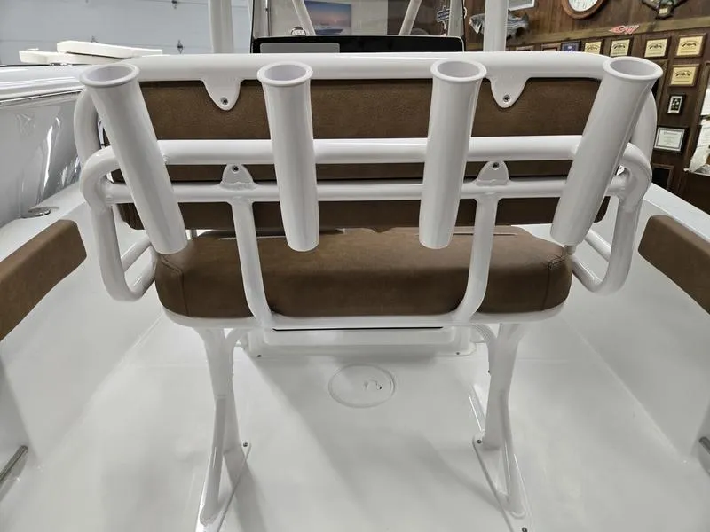 Slide: The Image of 2025 Sea Hunt Ultra 229 boat seat with rod holders, white and brown design. - 10