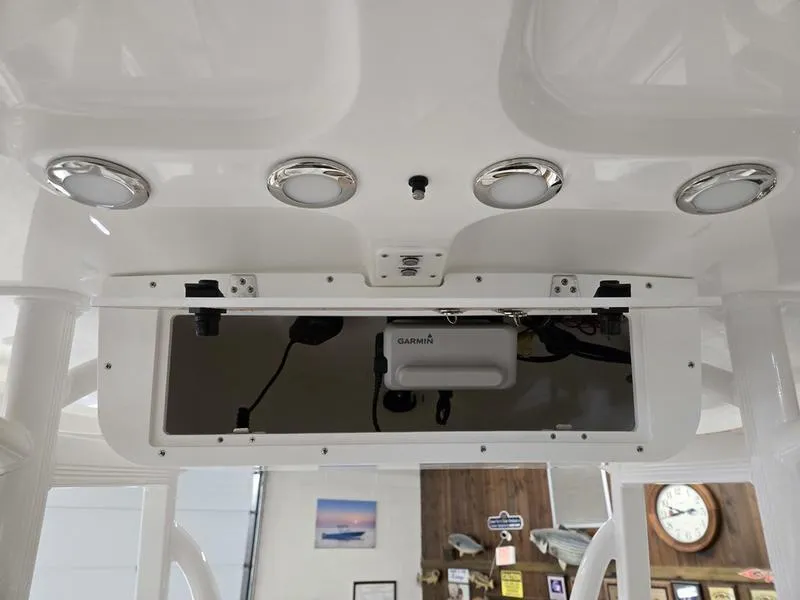 Slide: The Image of 2025 Sea Hunt Ultra 229 boat console with Garmin electronics and overhead lighting. - 12