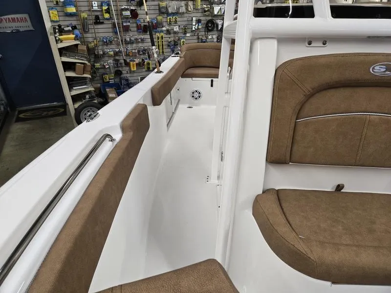 Slide: The Image of 2025 Sea Hunt Ultra 229 boat interior with tan seating and white deck. - 18