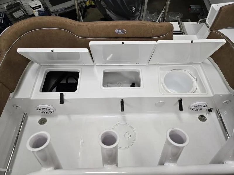 Slide: The Image of 2025 Sea Hunt Ultra 229 boat interior with storage compartments and rod holders. - 5