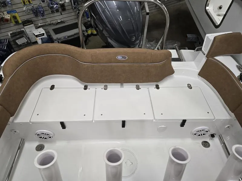 Slide: The Image of 2025 Sea Hunt Ultra 229 boat interior with cushioned seating and storage compartments. - 6