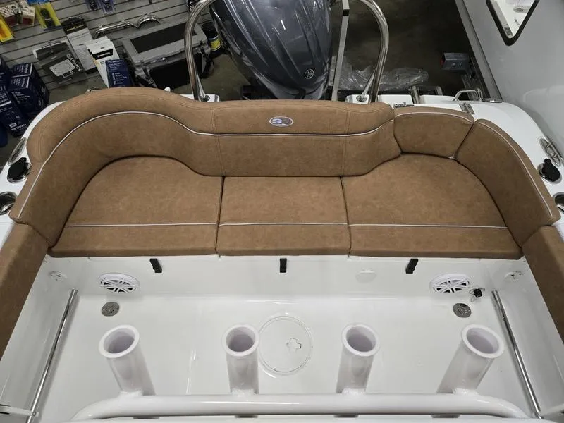 Slide: The Image of 2025 Sea Hunt Ultra 229 boat interior with tan seating and rod holders. - 7
