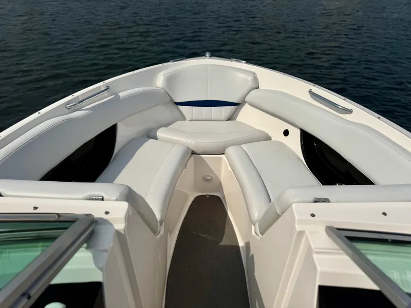 Slide: The Image of 2008 Regal 2200 Bowrider boat with white seating, on calm water. - 10