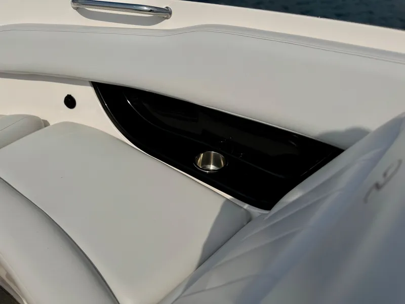 Slide: The Image of 2008 Regal 2200 Bowrider interior with white seating and cup holder. - 9