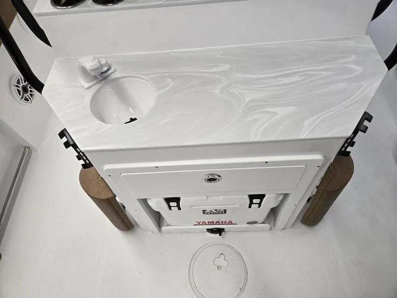 Slide: The Image of 2025 Sea Hunt Ultra 265SE boat interior with Yamaha cooler and storage area. - 13