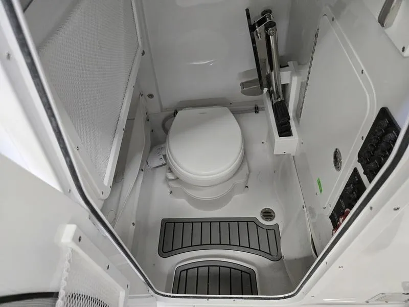 Slide: The Image of Interior of 2025 Sea Hunt Ultra 265SE boat bathroom with modern amenities. - 17