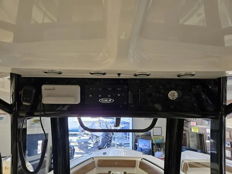 Slide: The Image of 2025 Sea Hunt Ultra 265SE boat dashboard with navigation equipment and controls. - 19