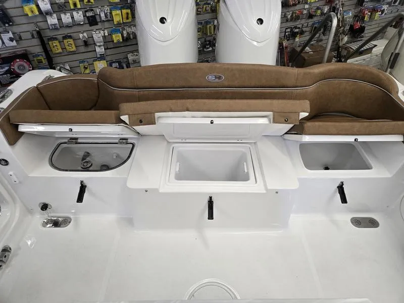 Slide: The Image of 2025 Sea Hunt Ultra 265SE boat interior with storage compartments and cushioned seating. - 3