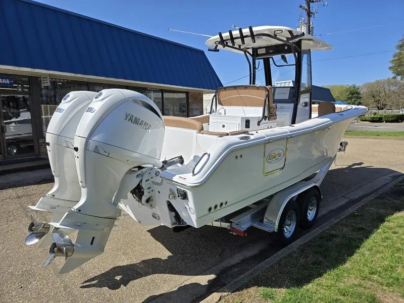 Slide: The Image of 2025 Sea Hunt Ultra 265SE boat with dual Yamaha engines on a trailer. - 4