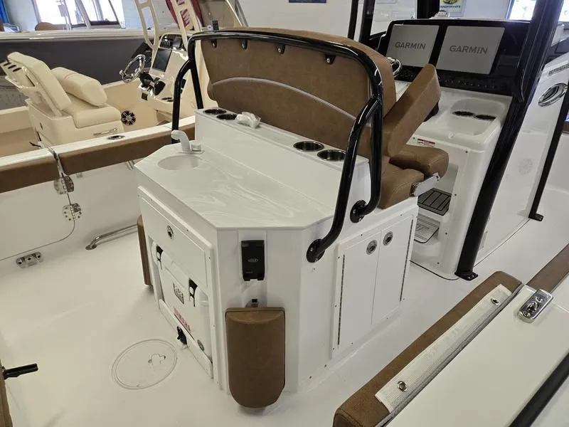 Slide: The Image of 2025 Sea Hunt Ultra 265SE boat interior with seating and Garmin electronics. - 6