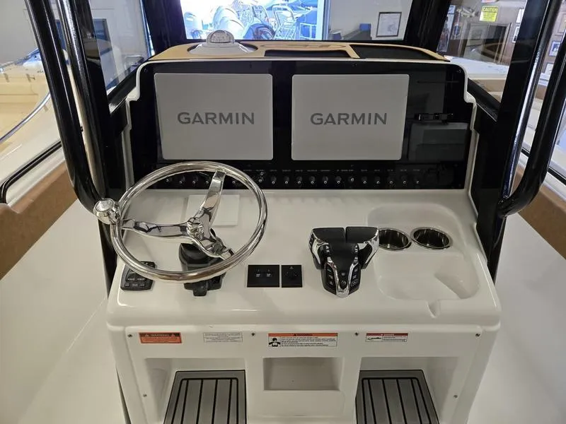 Slide: The Image of Control console of 2025 Sea Hunt Ultra 265SE with dual Garmin displays. - 7