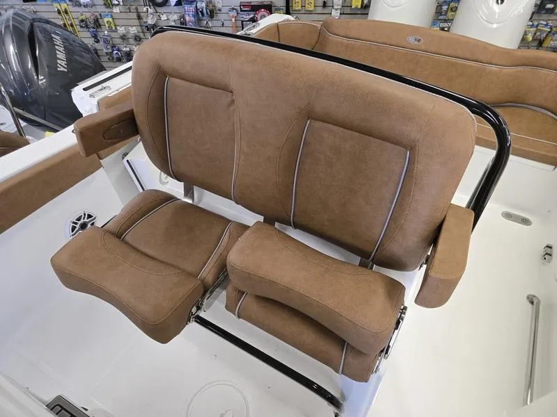 Slide: The Image of 2025 Sea Hunt Ultra 265SE boat seating with brown upholstery. - 9
