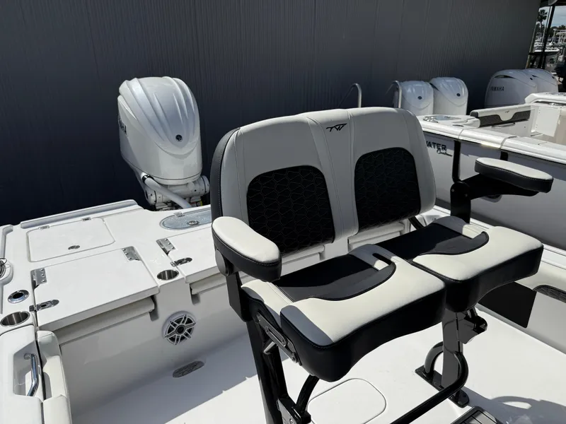 Slide: The Image of 2025 Tidewater 2500 Carolina Bay boat with dual seating and outboard motor. - 2