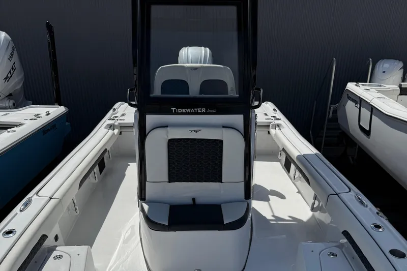 Slide: The Image of 2025 Tidewater 2500 Carolina Bay boat interior with sleek seating and console design. - 9