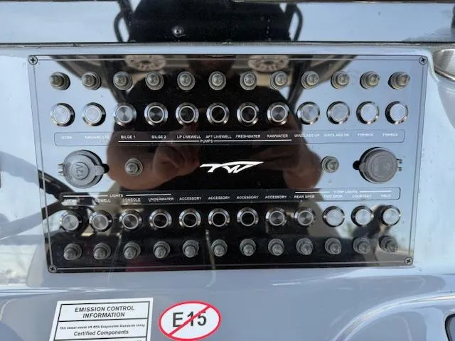 Slide: The Image of Control panel of 2025 Tidewater 320 CC Adventure boat with various switches and labels. - 11