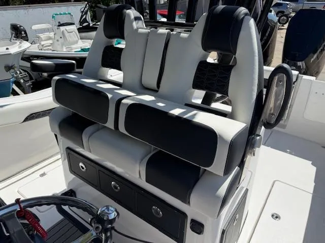 Slide: The Image of 2025 Tidewater 320 CC Adventure boat seating with black and white upholstery. - 16