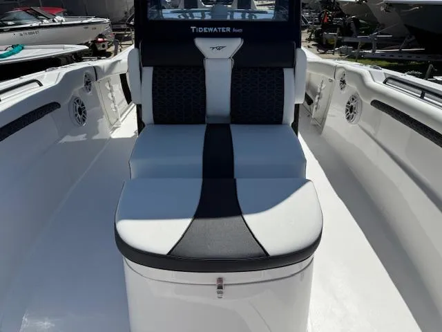 Slide: The Image of 2025 Tidewater 320 CC Adventure boat interior with cushioned seating and sleek design. - 19
