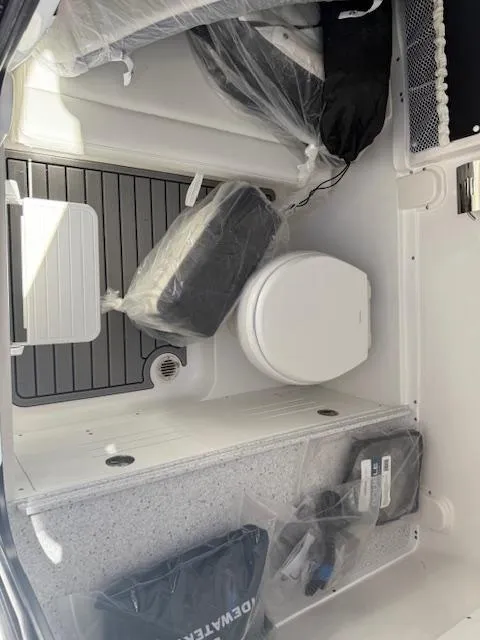 Slide: The Image of 2025 Tidewater 320 CC Adventure boat interior with toilet and storage. - 20