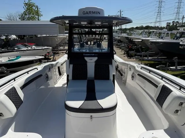 Slide: The Image of 2025 Tidewater 320 CC Adventure boat with Garmin equipment, docked among other boats. - 23