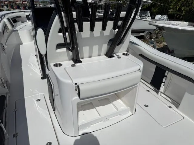 Slide: The Image of 2025 Tidewater 320 CC Adventure boat interior with rod holders and storage compartment. - 4