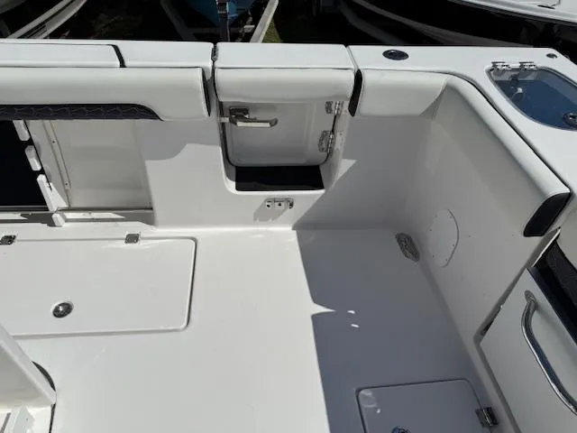 Slide: The Image of 2025 Tidewater 320 CC Adventure boat interior with storage compartments and seating. - 7