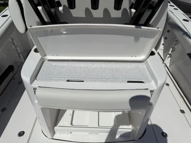 Slide: The Image of 2025 Tidewater 320 CC Adventure boat interior with open storage compartment. - 9