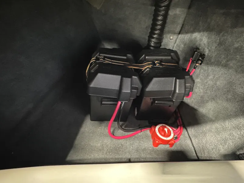 Slide: The Image of Dual battery setup in a 2002 Malibu Sunsetter boat with red wiring and switch. - 11