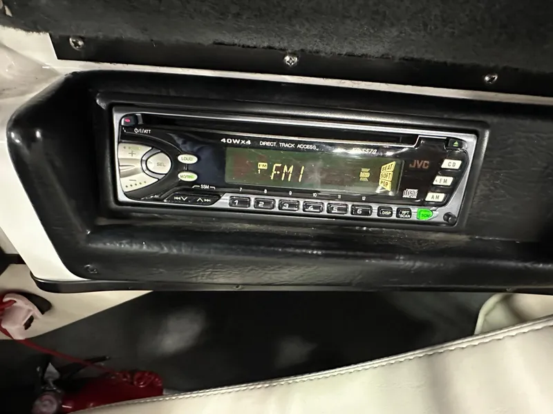 Slide: The Image of 2002 Malibu Sunsetter boat stereo system displaying FM radio station. - 12