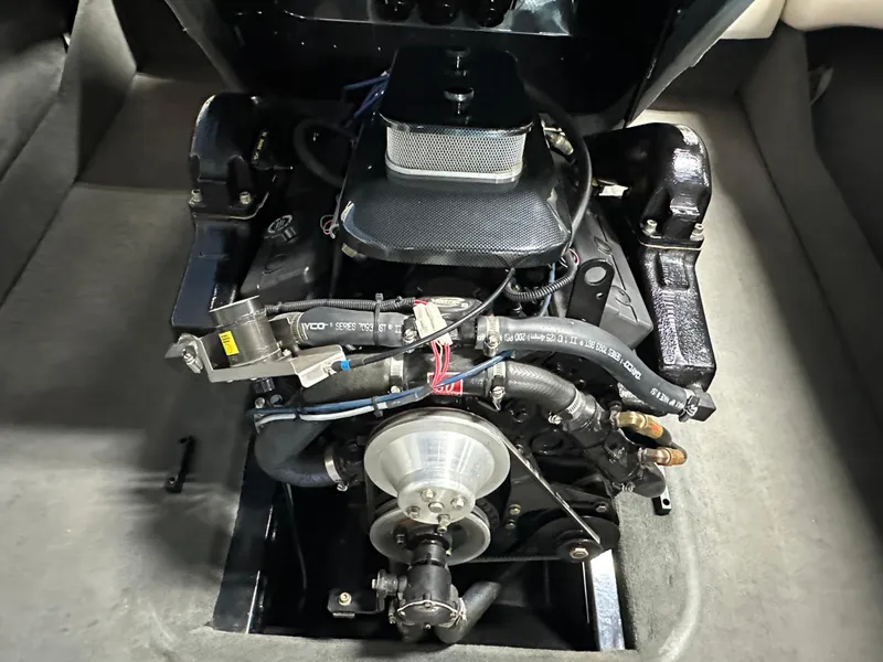 Slide: The Image of 2002 Malibu Sunsetter engine compartment, showcasing detailed mechanical components and wiring. - 17