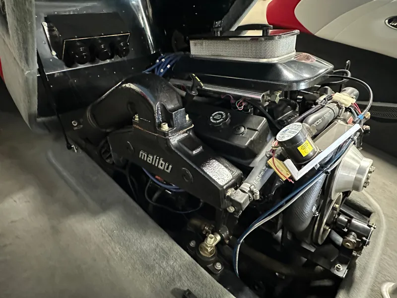 Slide: The Image of 2002 Malibu Sunsetter boat engine, detailed view of components and branding. - 18