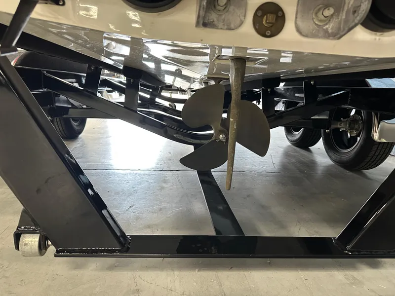 Slide: The Image of 2002 Malibu Sunsetter boat propeller and trailer detail in a garage setting. - 4