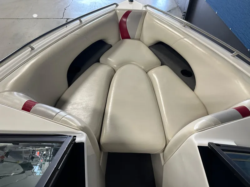 Slide: The Image of 2002 Malibu Sunsetter boat interior with white and red cushioned seating. - 6