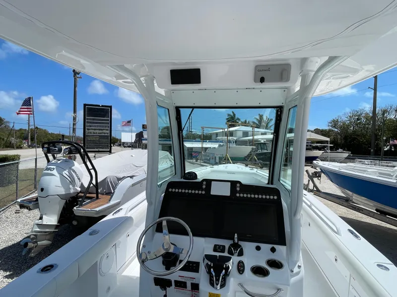 Slide: The Image of 2025 Everglades 273CC boat interior with steering console and dual screens. - 12