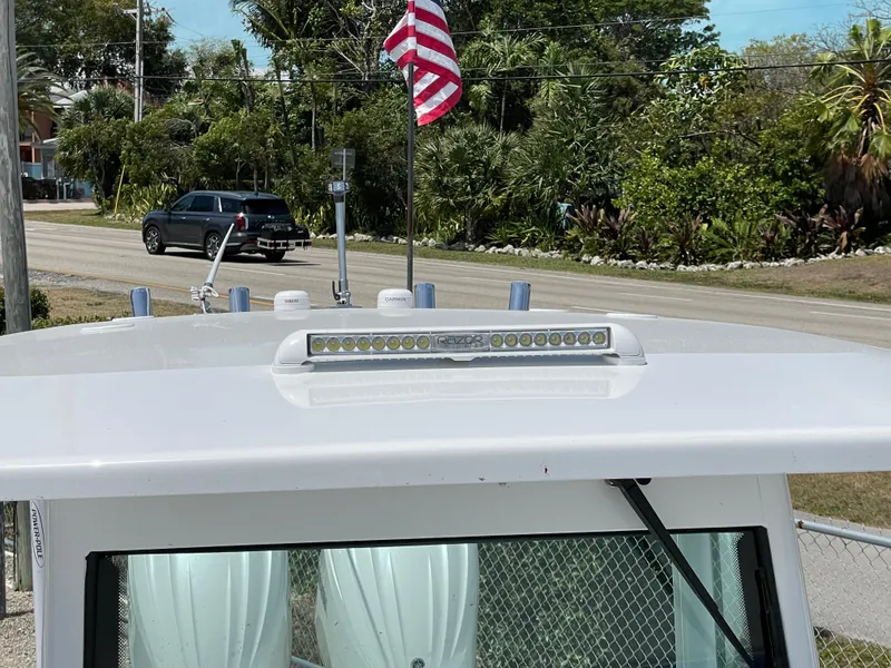 Slide: The Image of 2025 Everglades 273CC boat roof with LED light bar and American flag. - 16