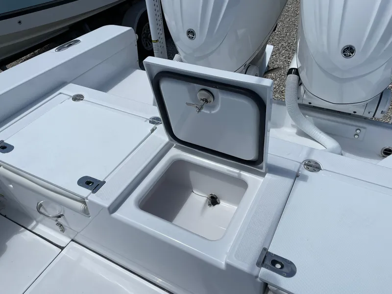 Slide: The Image of 2025 Everglades 273CC boat with open storage compartment and dual engines. - 20