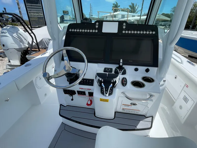 Slide: The Image of 2025 Everglades 273CC boat cockpit with modern controls and dual screens. - 4