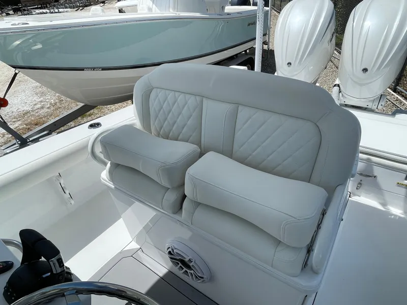 Slide: The Image of 2025 Everglades 273CC boat interior with cushioned seating and steering wheel. - 8