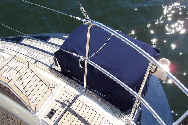 Slide: The Image of Sailboat deck of 1994 C&C 51 XL C/B with covered equipment, sunlit water background. - 10