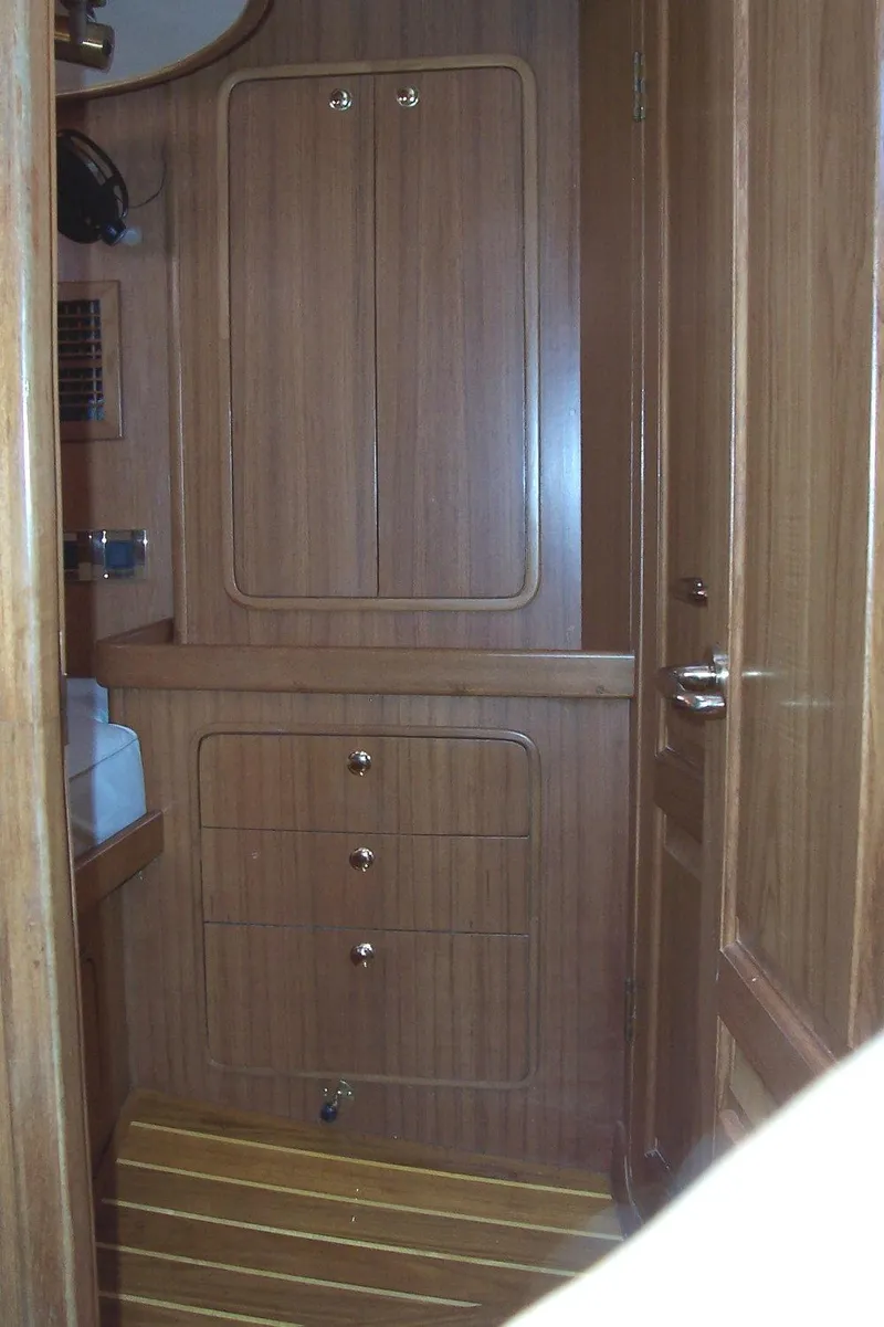 Slide: The Image of Wooden interior of 1994 C&C 51 XL C/B yacht, featuring cabinets and striped flooring. - 24