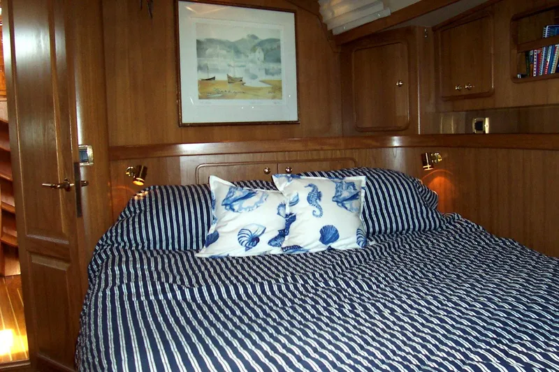 Slide: The Image of Cozy cabin interior of 1994 C&C 51 XL C/B yacht with striped bedding and nautical decor. - 27