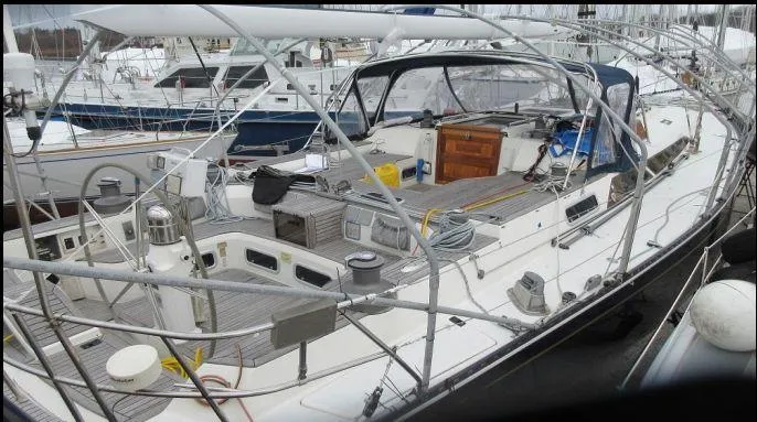 Slide: The Image of Sailboat docked in marina, 1994 C&C 51 XL C/B model, featuring spacious deck and cockpit. - 31