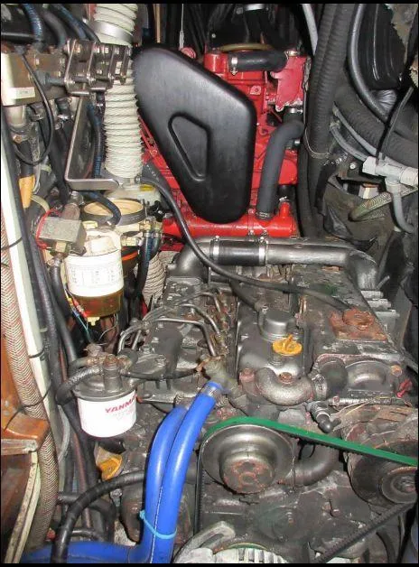 Slide: The Image of Engine compartment of a 1994 C&C 51 XL C/B sailboat, featuring Yanmar components. - 34