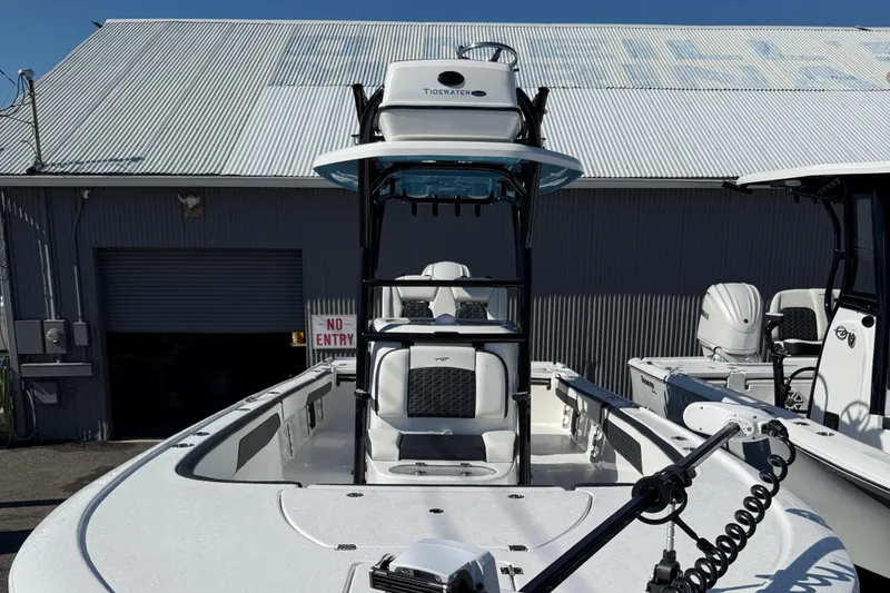 Slide: The Image of 2025 Tidewater 2700 Carolina Bay boat docked near a metal building. - 12