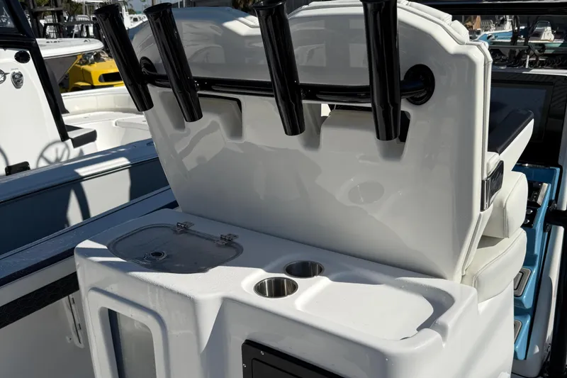 Slide: The Image of 2025 Tidewater 2700 Carolina Bay boat console with rod holders and cup holders. - 7