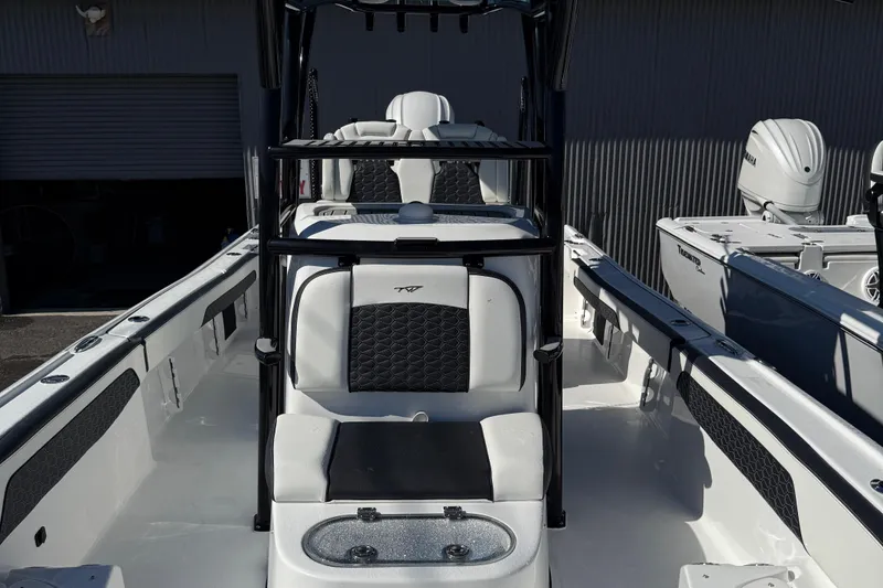 Slide: The Image of 2025 Tidewater 2700 Carolina Bay boat interior with seating and console. - 8