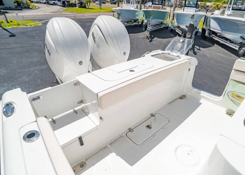 Slide: The Image of 2025 Sea Hunt Gamefish 25 boat with dual outboard motors, spacious deck, and storage compartments. - 10