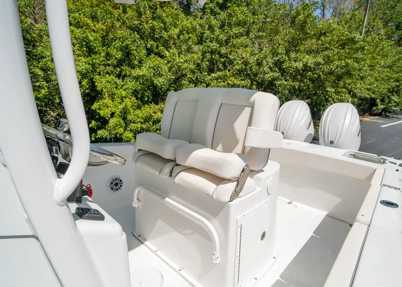 Slide: The Image of 2025 Sea Hunt Gamefish 25 boat interior with cushioned seating and dual Yamaha engines. - 13
