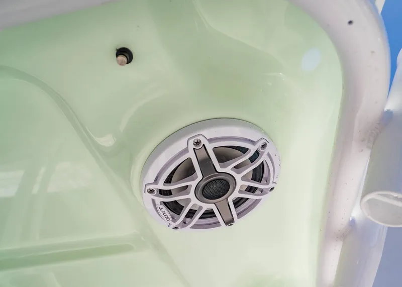 Slide: The Image of Speaker on 2025 Sea Hunt Gamefish 25 boat, mounted on light green surface. - 14